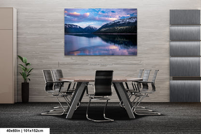 a dining room table with chairs and a painting on the wall