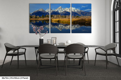 a dining room table with four chairs and a painting on the wall