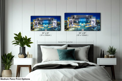 a bed room with a neatly made bed and two pictures on the wall