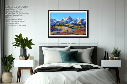 a bedroom with a bed and a painting on the wall
