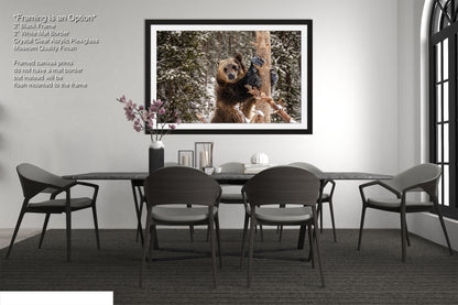 a dining room table with chairs and a picture hanging on the wall
