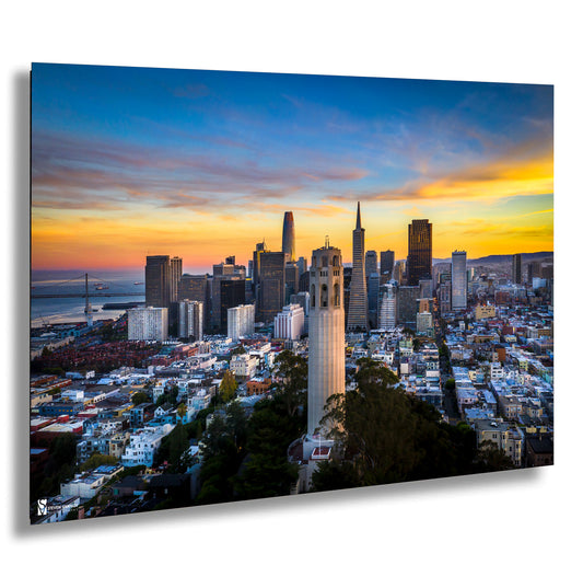 a view of a city with a sunset in the background
