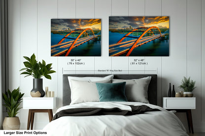 a bed with two pictures of a bridge hanging on the wall