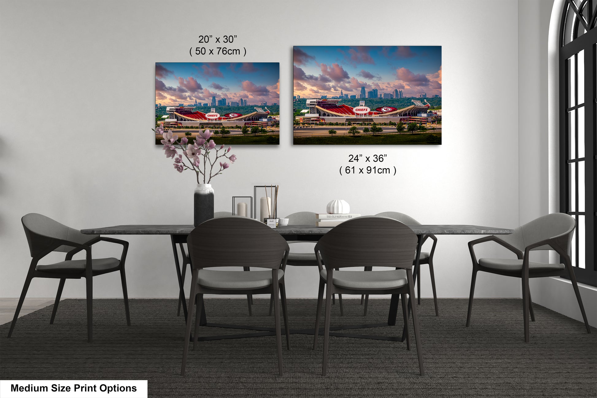 a dining room table with four chairs and a vase with flowers