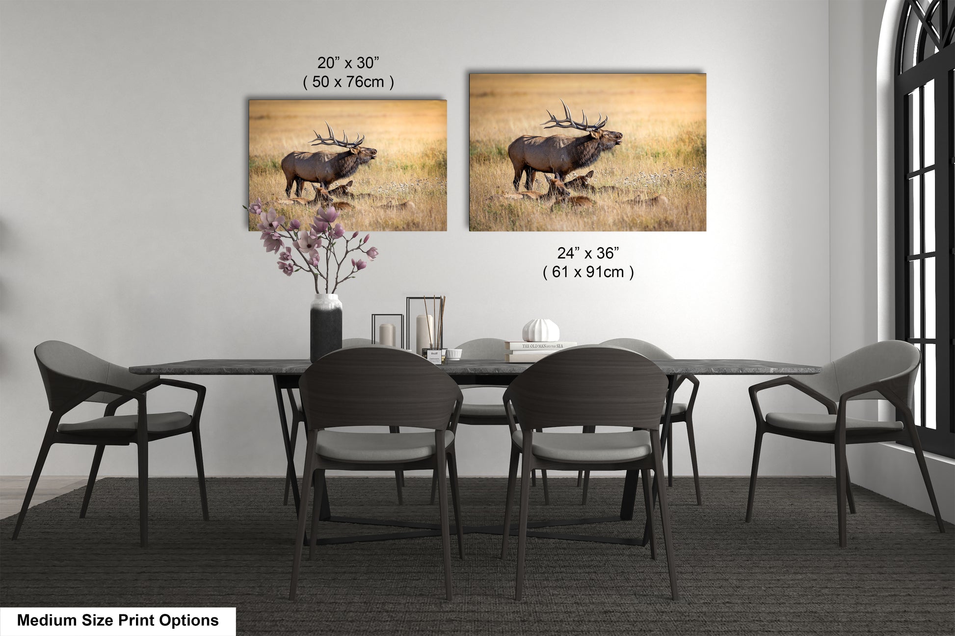 a dining room table with four chairs and a picture of an elk