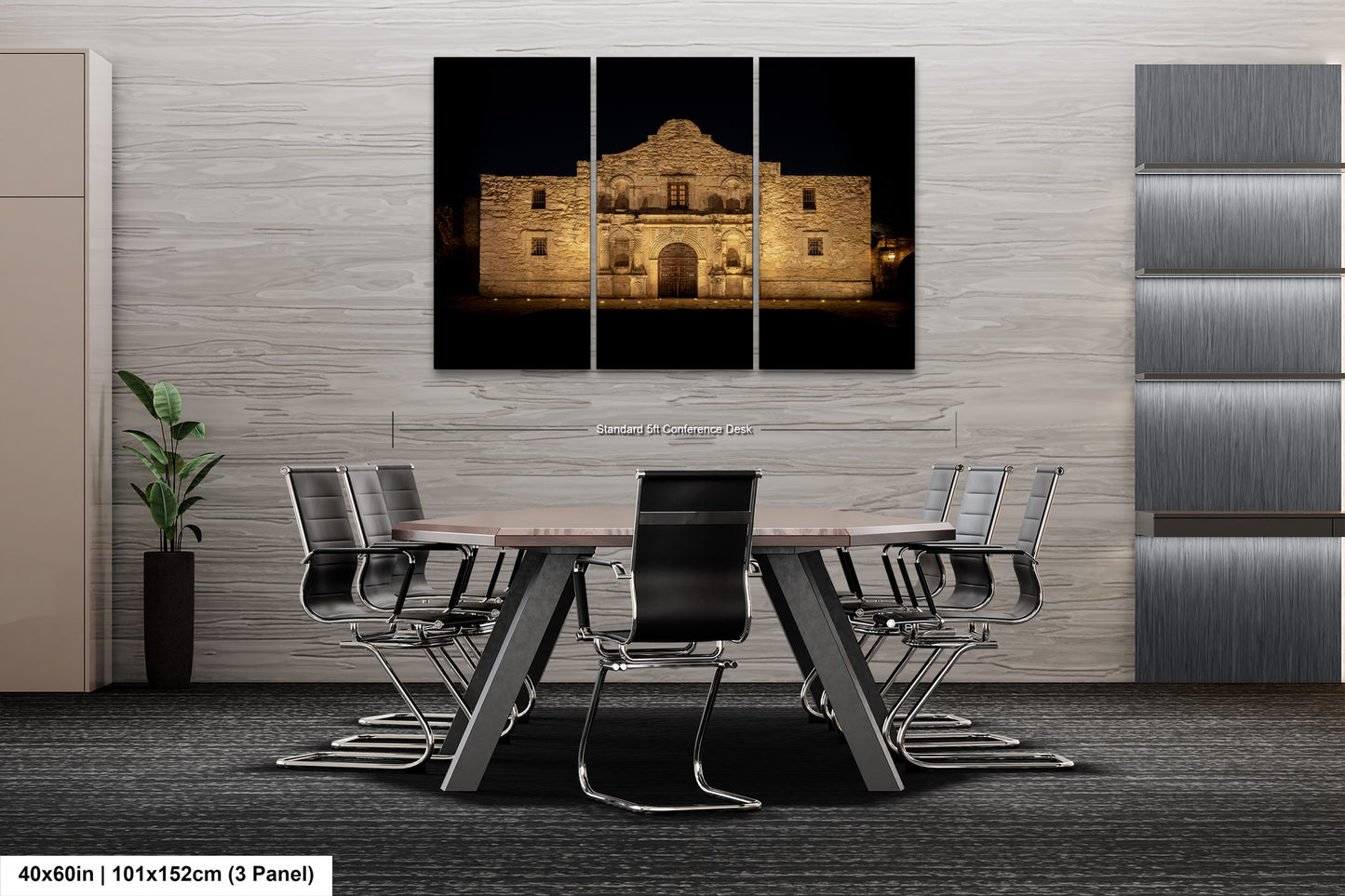a modern office space with a large, illuminated photograph of the Alamo in the background. The photograph is displayed on a wall above a conference table, which is surrounded by chairs. The office has a minimalist and contemporary design, with gray walls and a gray carpeted floor.
