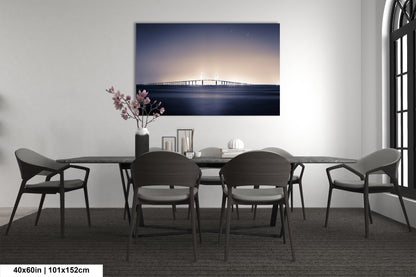 a dining room table with chairs and a painting on the wall
