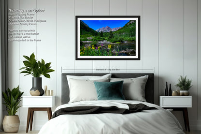 a bedroom with a bed and a picture hanging on the wall