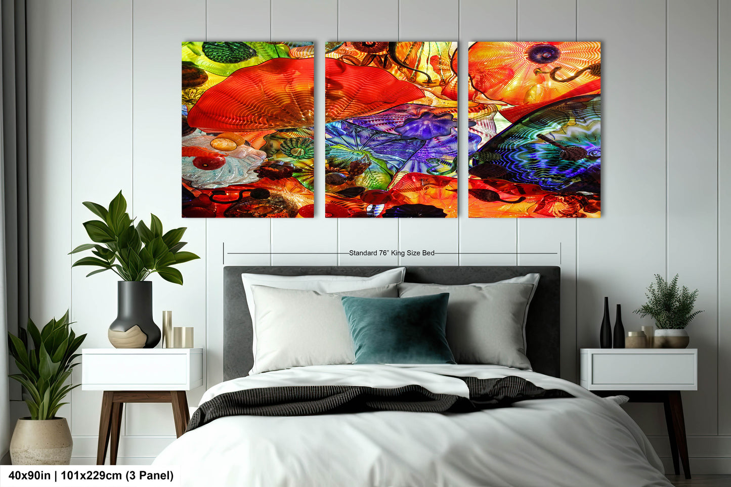 a bedroom with a bed and two paintings on the wall