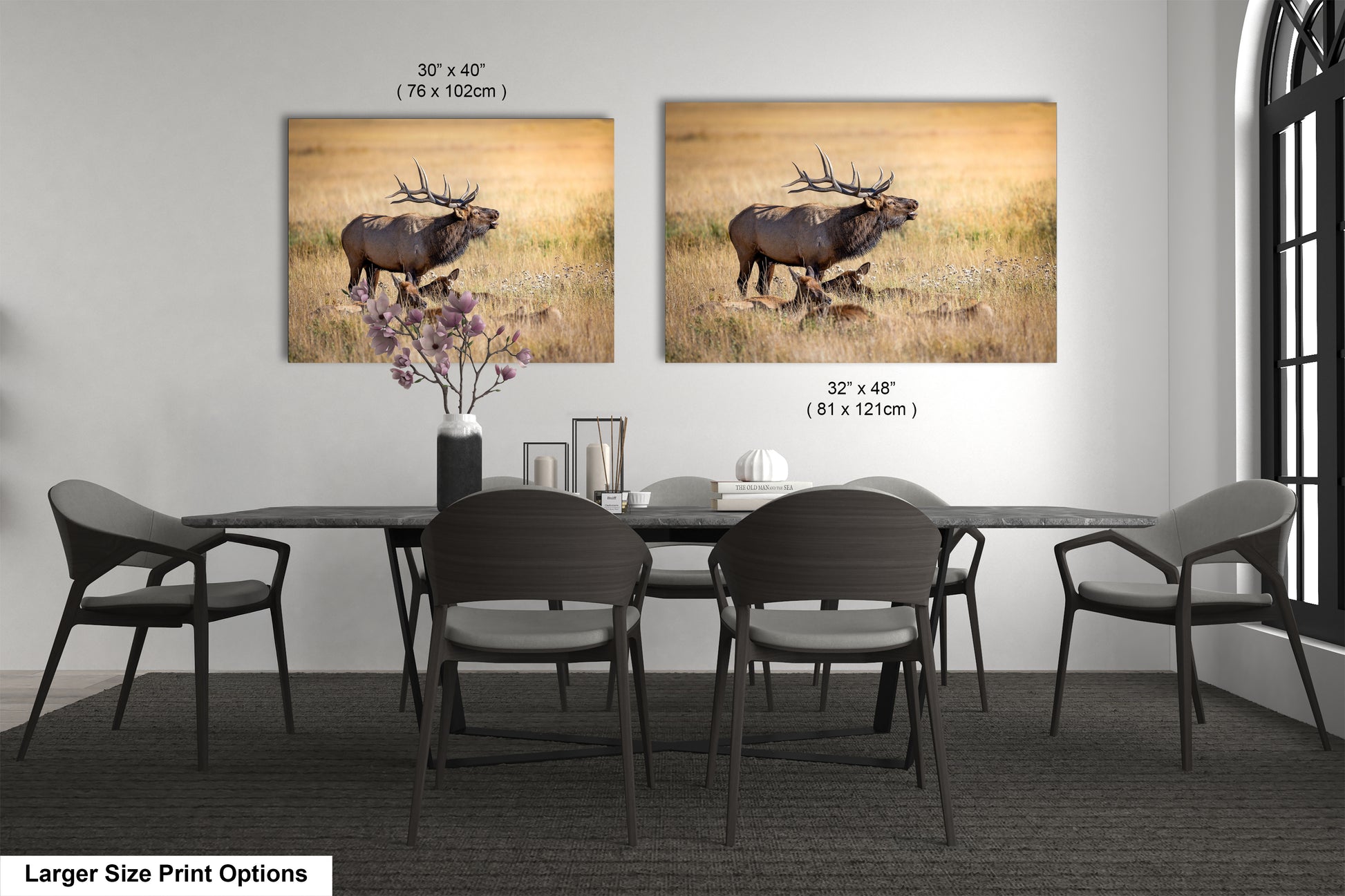 a dining room table with four chairs and a picture of an elk