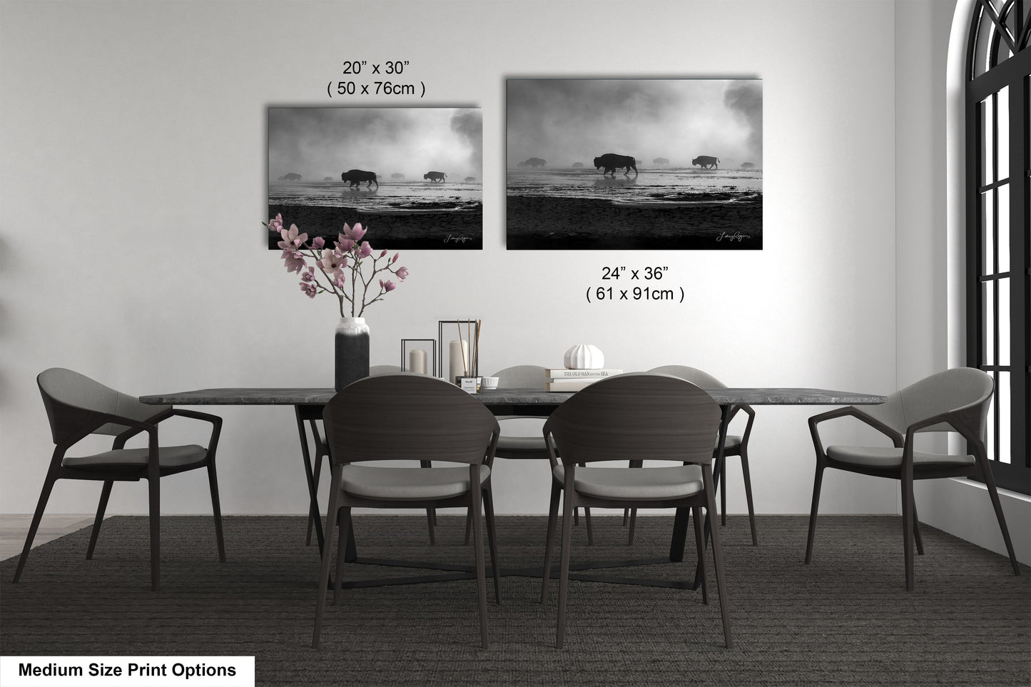 a dining table with four chairs and a vase of flowers