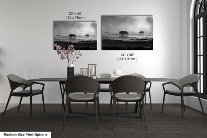 a dining table with four chairs and a vase of flowers