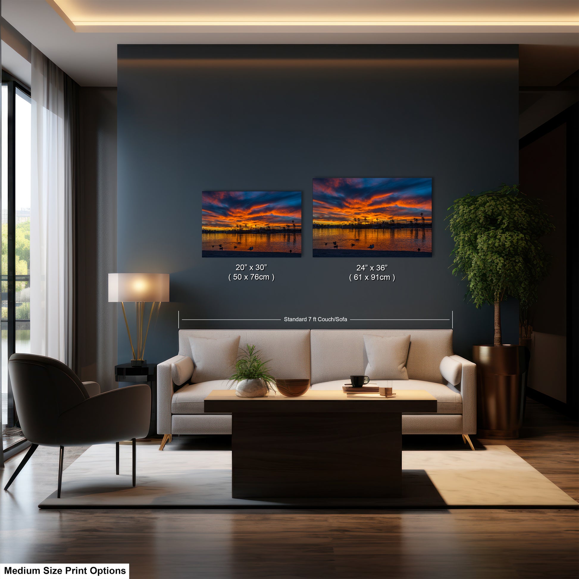 a modern living room with a large window, a white sofa, a coffee table, and a potted plant. The room has a minimalist and contemporary design, with a large wall art piece featuring a sunset landscape as the focal point.