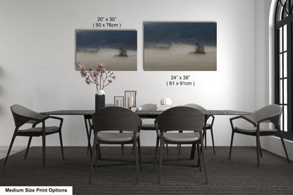 a dining table with four chairs and a vase of flowers