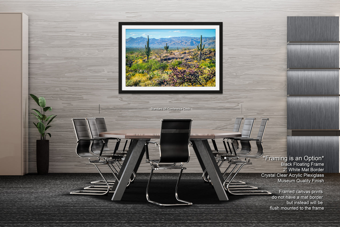 a modern office space with a large framed landscape painting hanging on the wall above a wooden table surrounded by black chairs.