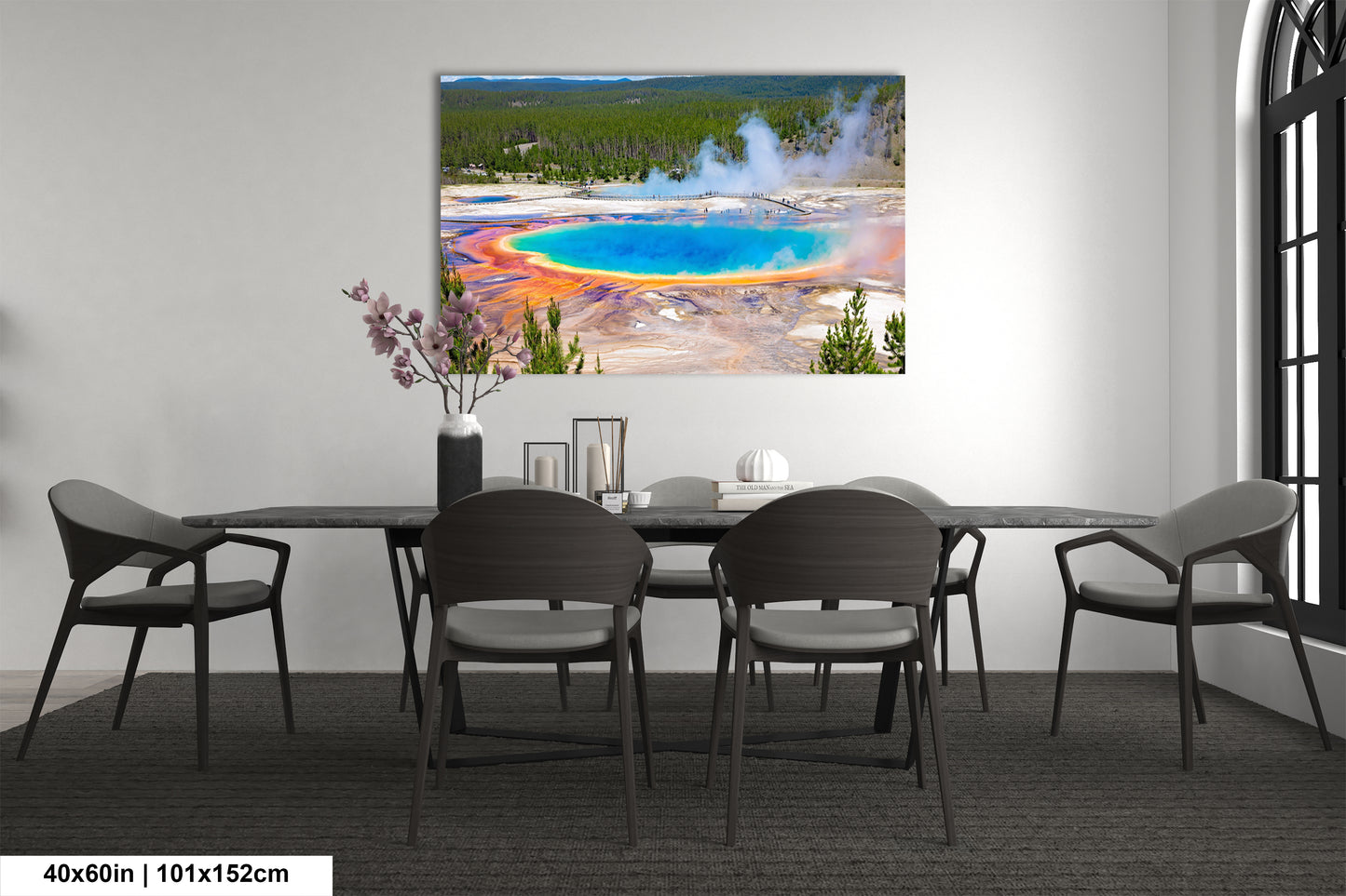 a dining room table with chairs and a painting on the wall