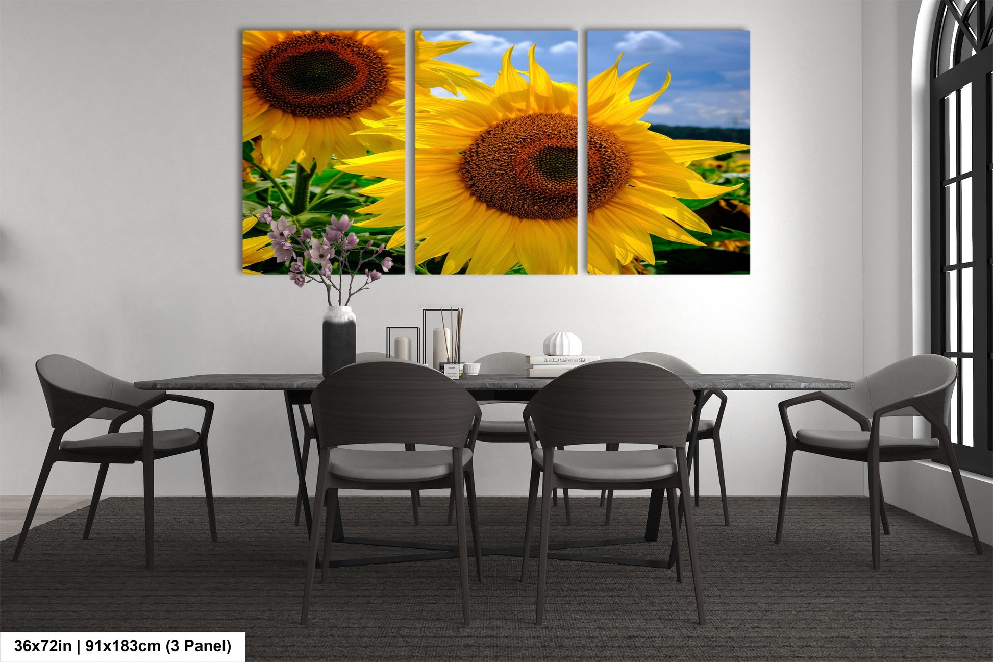 a dining room table with a vase of sunflowers on it