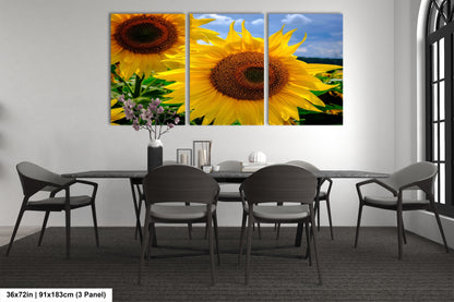 a dining room table with a vase of sunflowers on it