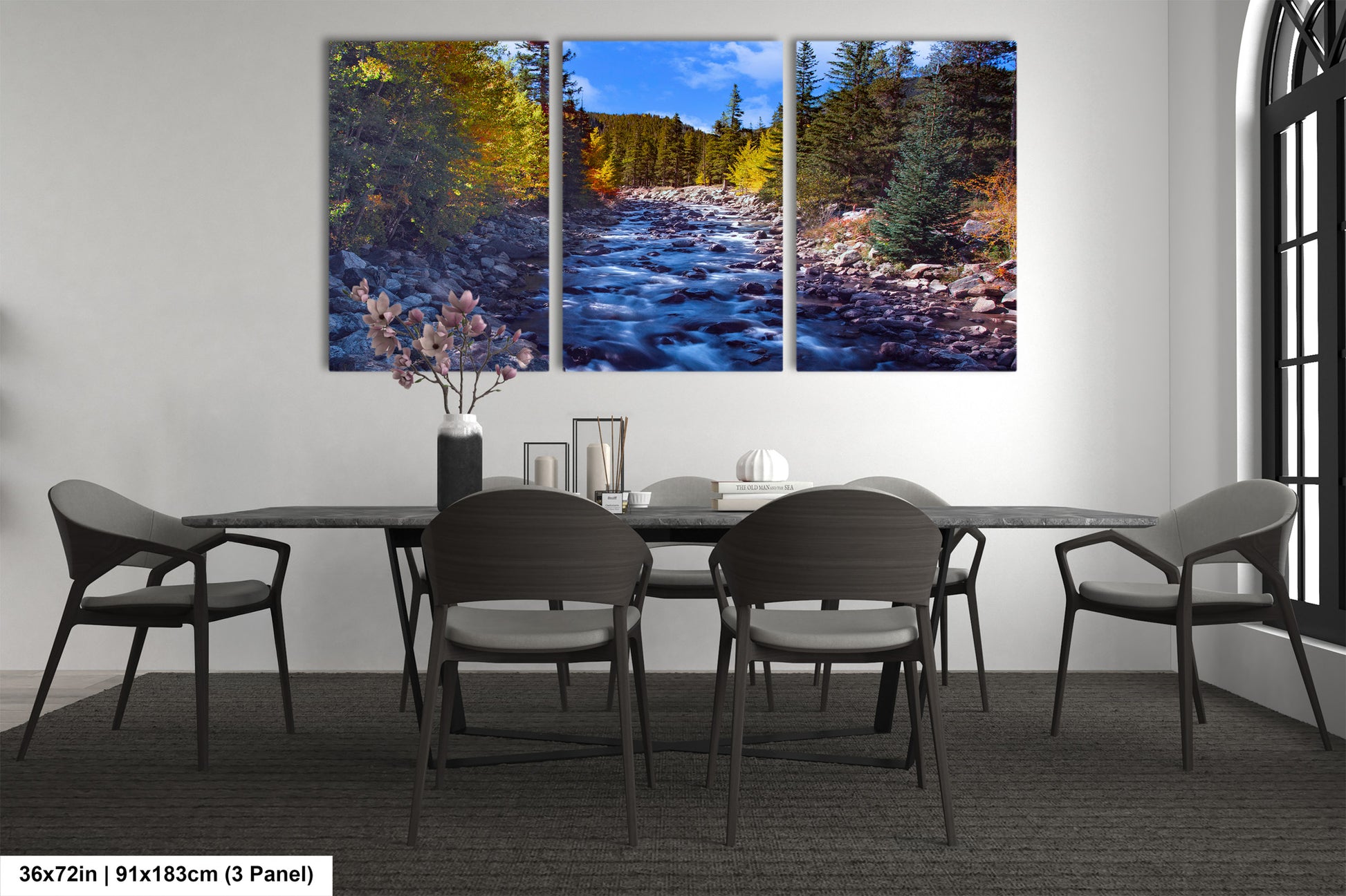 a dining room table with chairs and a painting on the wall
