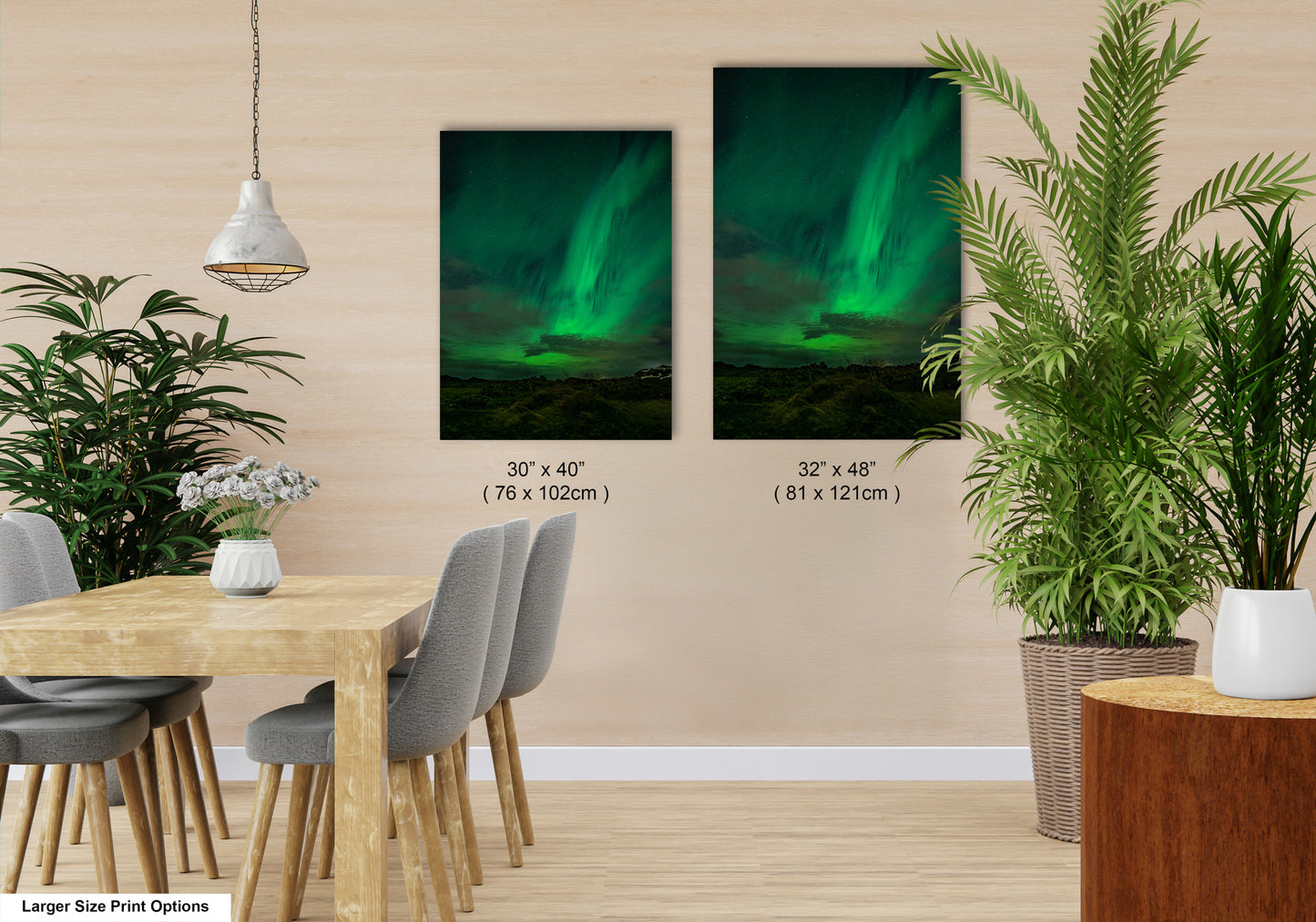 a modern dining room with a wooden table and chairs, a potted plant, and two framed prints of the northern lights on the wall.