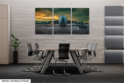 a dining room table with chairs and a painting of an airplane