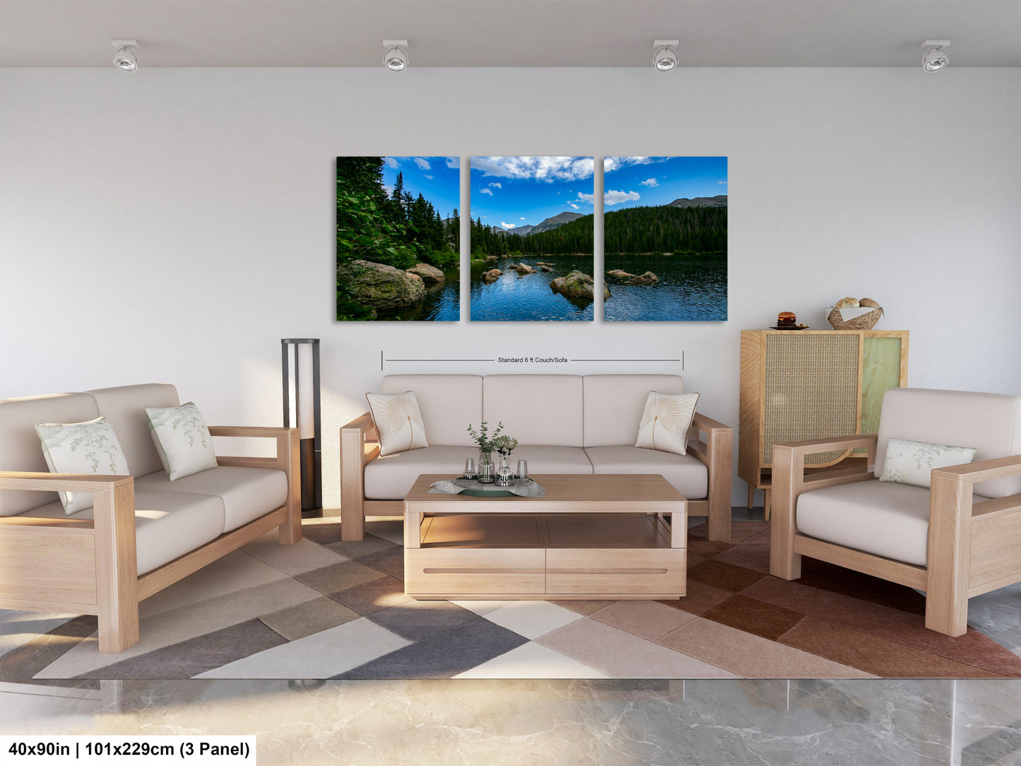 The image is a modern living room with a large, three-panel landscape painting hanging on the wall. The painting depicts a serene mountain lake surrounded by trees and mountains, creating a peaceful and natural atmosphere. The room is furnished with a sofa, two armchairs, and a coffee table, providing a comfortable and inviting space for relaxation and socializing.