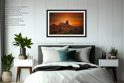a bedroom with a bed and a picture hanging on the wall