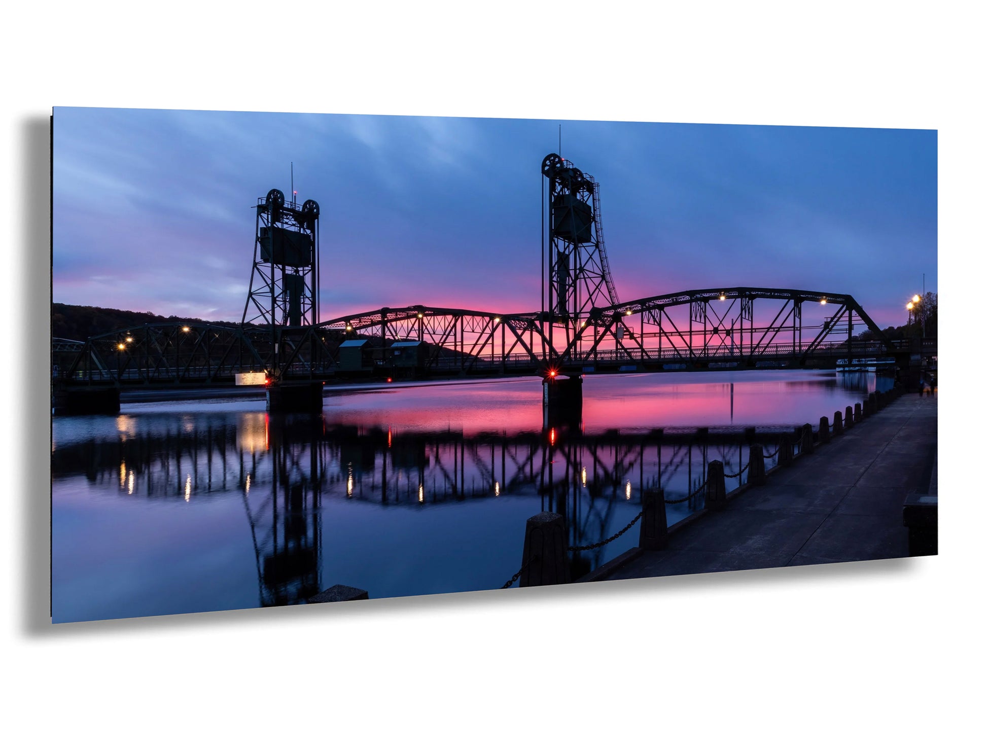 a bridge over a body of water at dusk