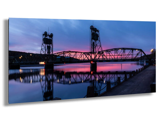 a bridge over a body of water at dusk