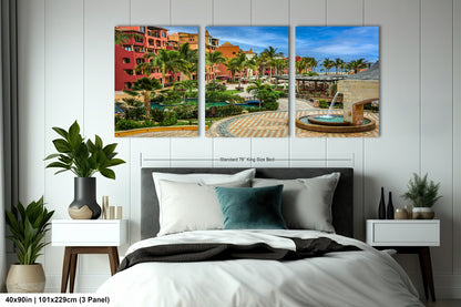 a bed room with a neatly made bed and paintings on the wall