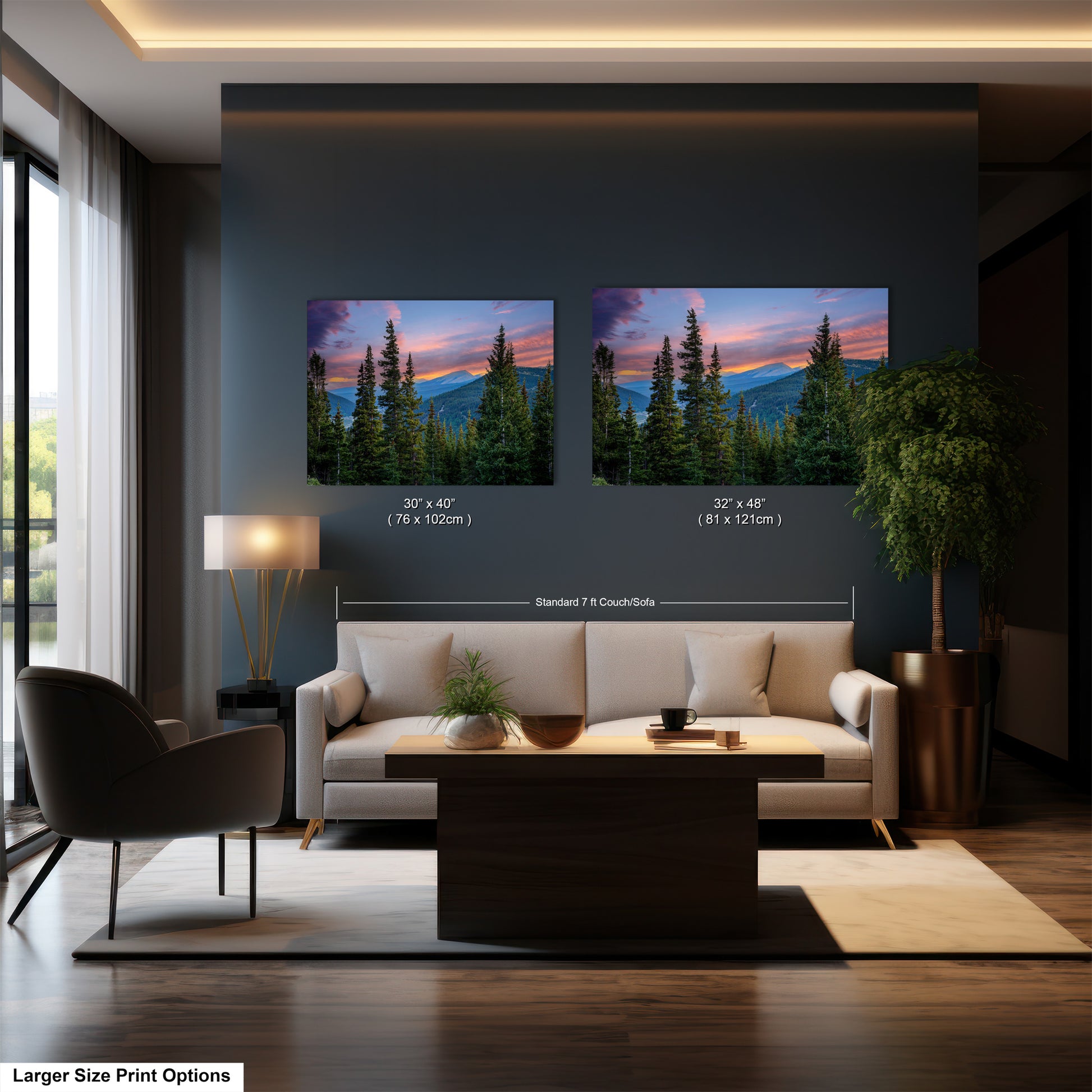 a modern living room with a large sofa, a coffee table, and a potted plant. There are two framed landscape paintings hanging on the wall above the sofa, depicting a scenic mountain view at sunset. The paintings are of similar size and style, and the text indicates that the larger size print options are available.