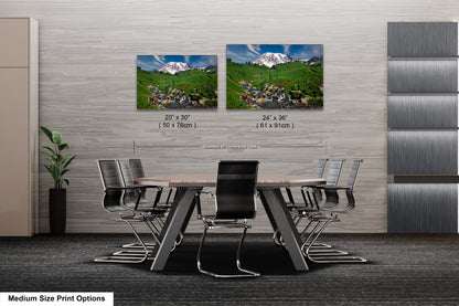 a dining room table with chairs and two pictures on the wall