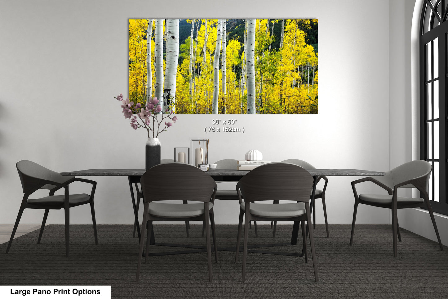 a dining room table with chairs and a vase of flowers