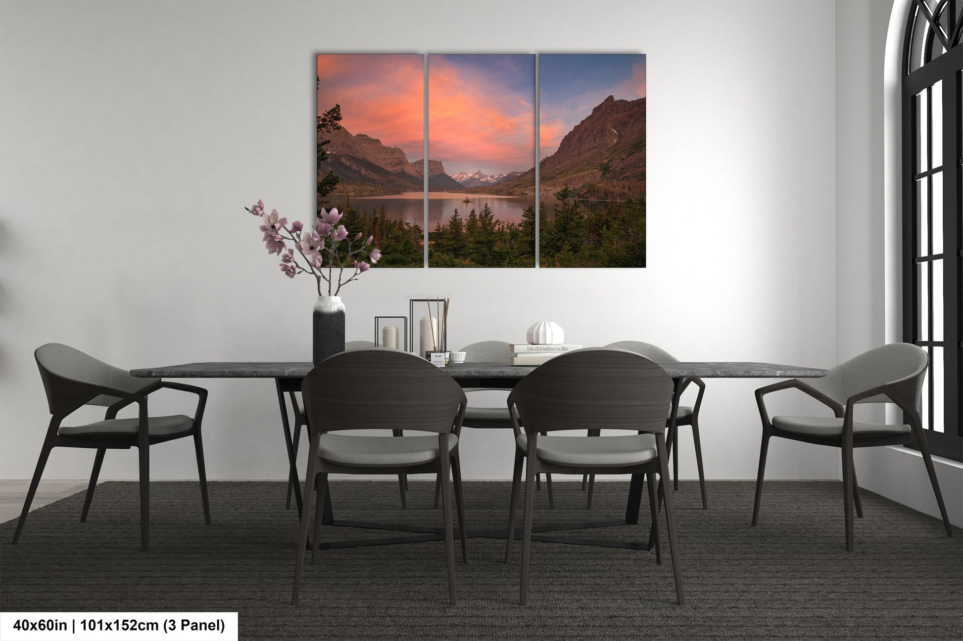 a dining room table with chairs and a painting on the wall