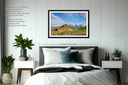 a bedroom with a bed and a picture hanging on the wall