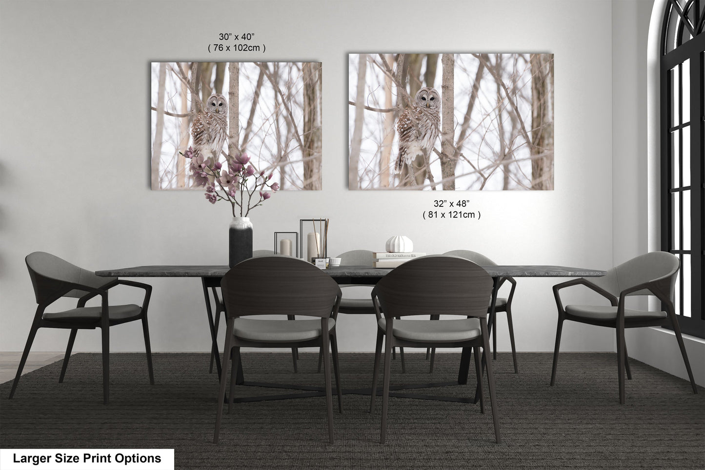 a dining room table with four chairs and a vase with flowers