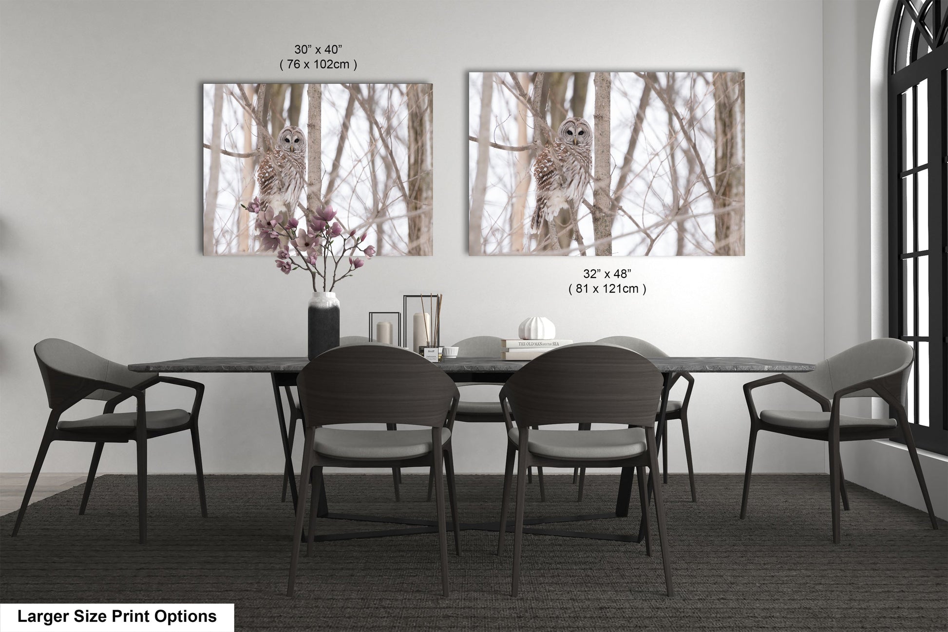 a dining room table with four chairs and a vase with flowers
