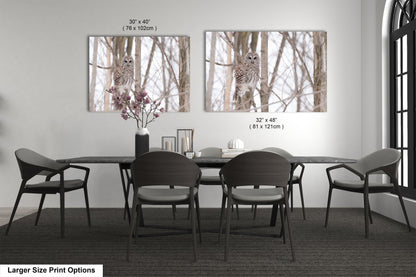 a dining room table with four chairs and a vase with flowers