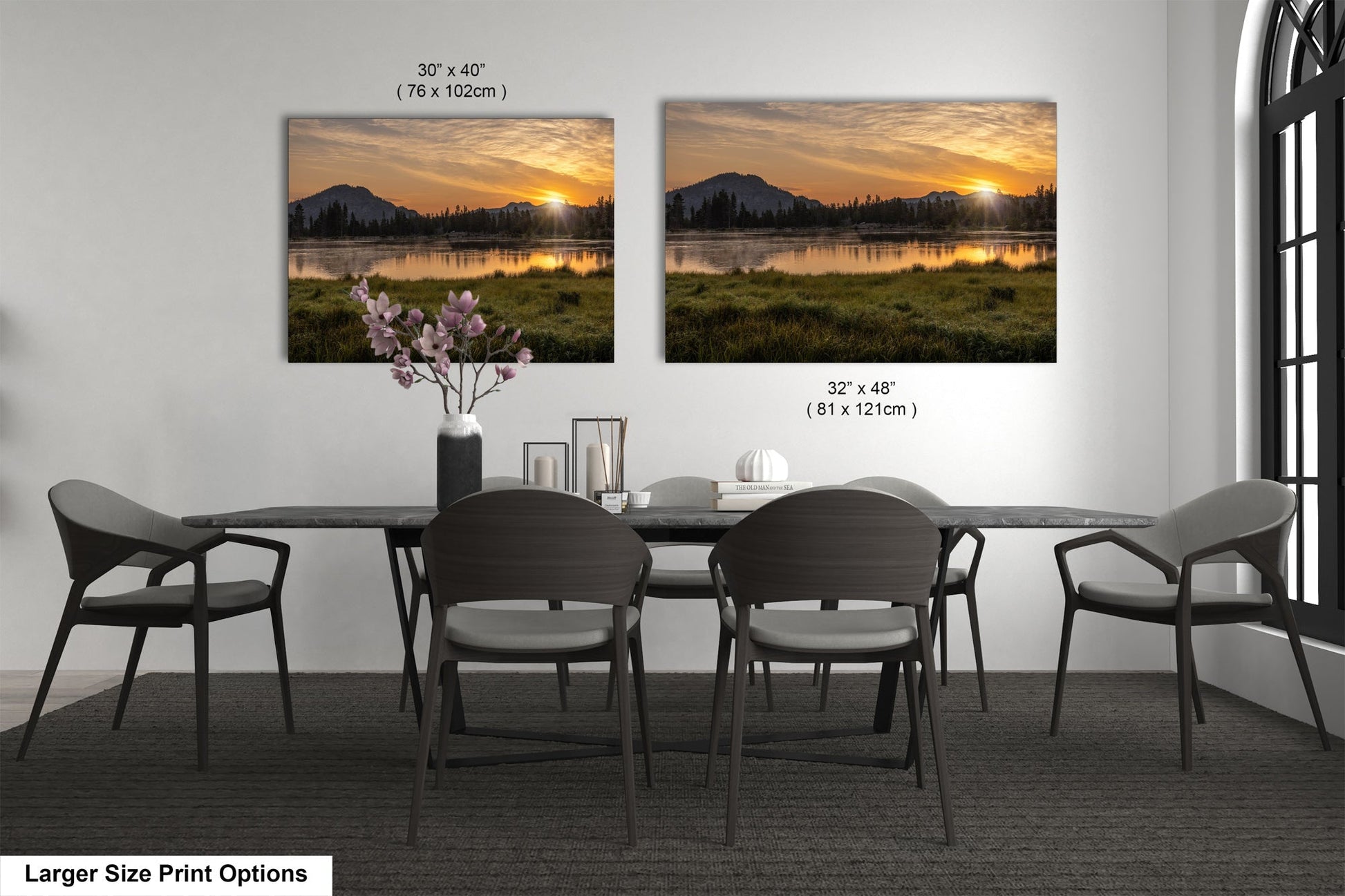 a dining room table with four chairs and a vase of flowers