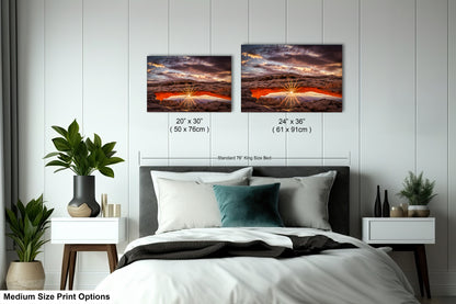 a bed with two pictures on the wall above it