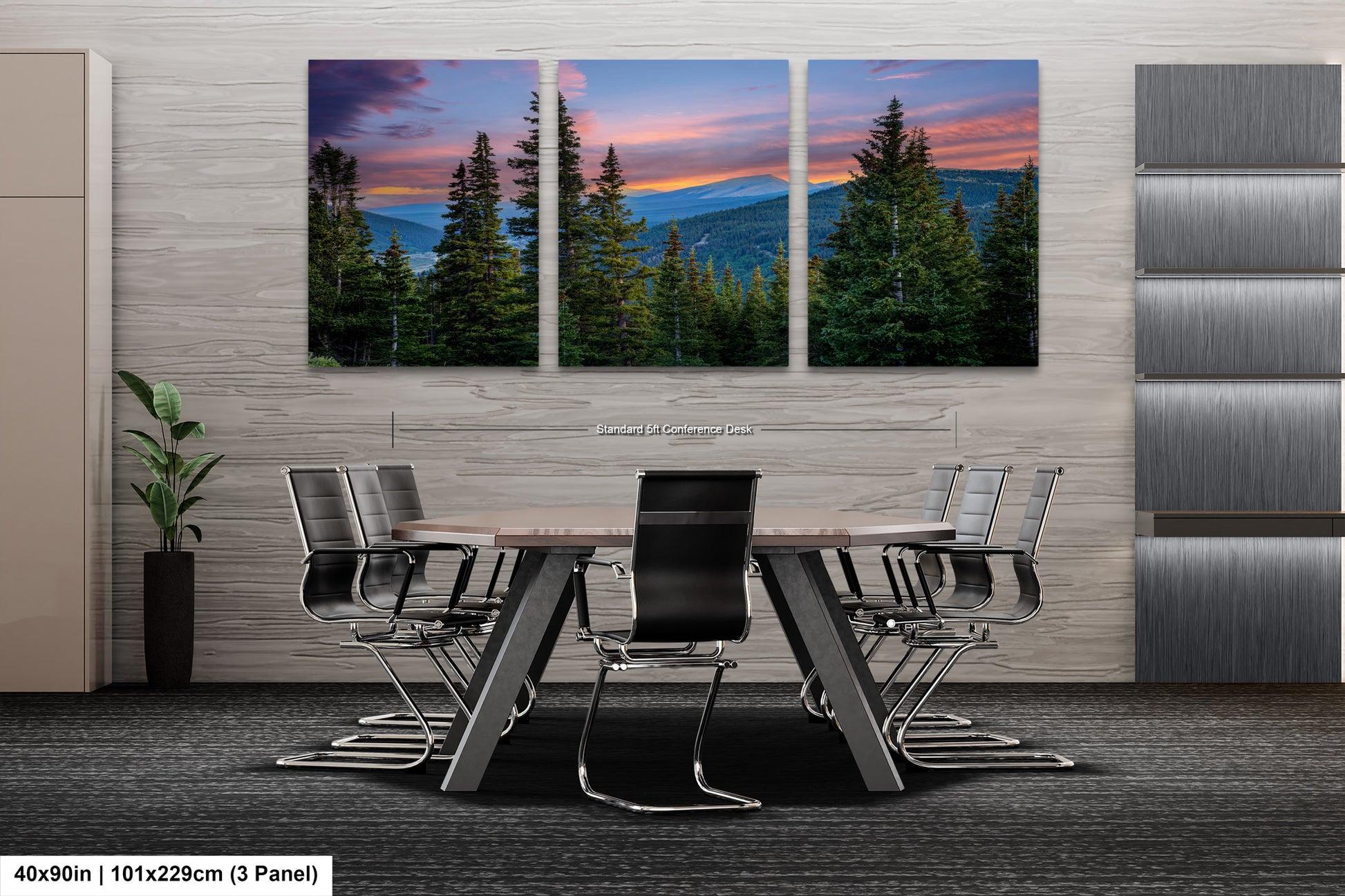 A modern office space with a large, three-panel landscape painting depicting a mountain range at sunset. The painting is mounted on the wall above a wooden table surrounded by chairs.