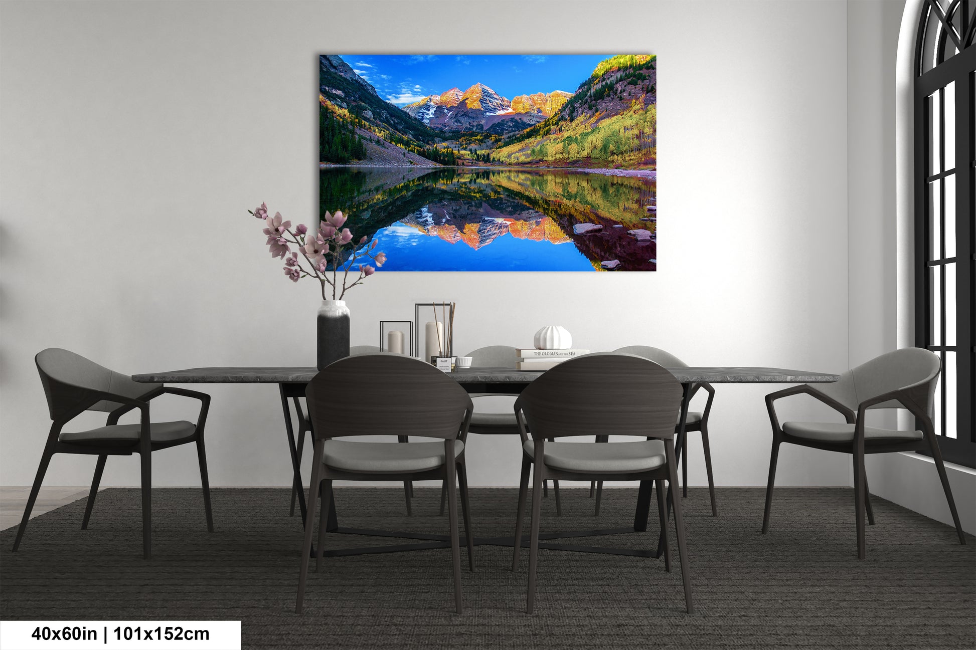 a dining room table with chairs and a painting on the wall