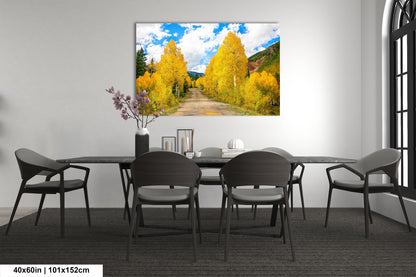 a dining room table with chairs and a painting on the wall