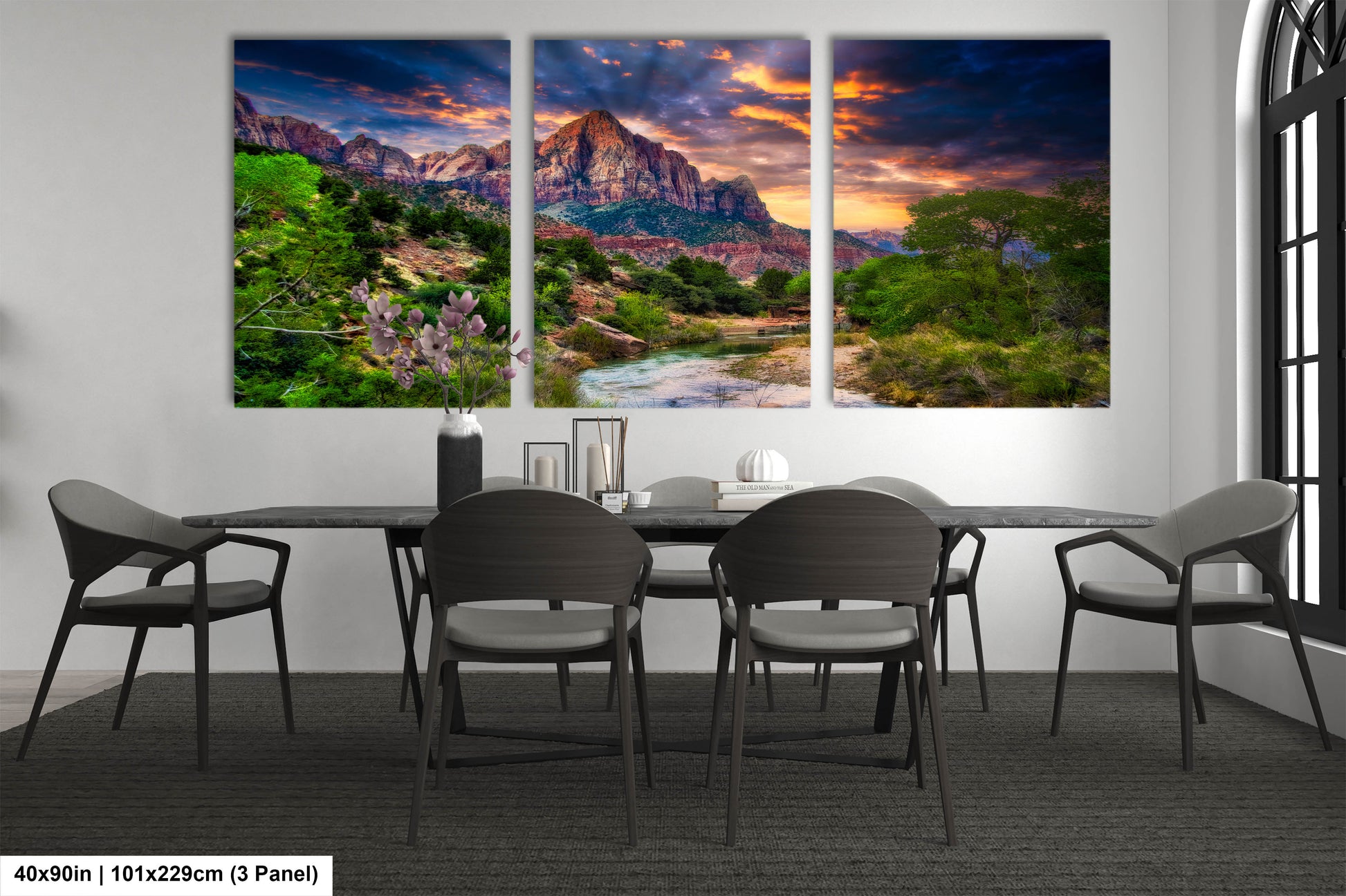 a dining room table with four chairs and a painting on the wall