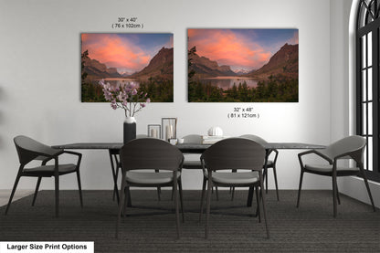 a dining room table with four chairs and a vase of flowers
