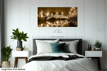 a bed room with a neatly made bed and a painting on the wall