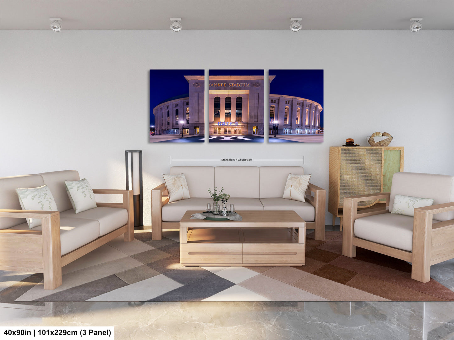 The image is a modern living room with a large, illuminated stadium in the background. The room is furnished with a sofa, two chairs, and a coffee table. The furniture appears to be made of wood and has a neutral color scheme. The room has a minimalist and clean design, with a geometric patterned rug on the floor.