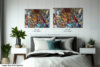 a bedroom with a bed and two pictures on the wall