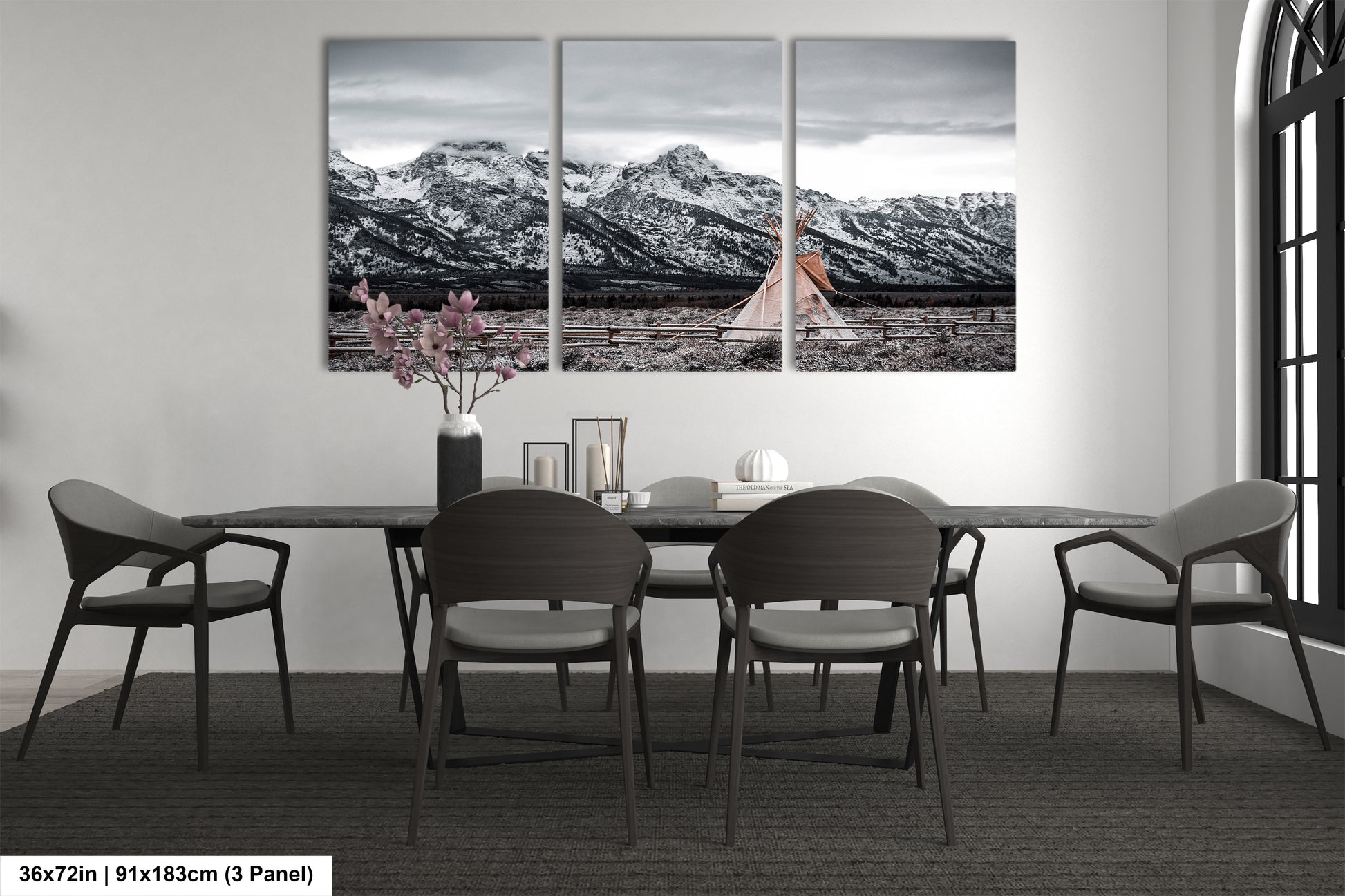 a dining room table with four chairs and a vase of flowers