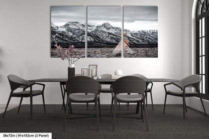 a dining room table with four chairs and a vase of flowers
